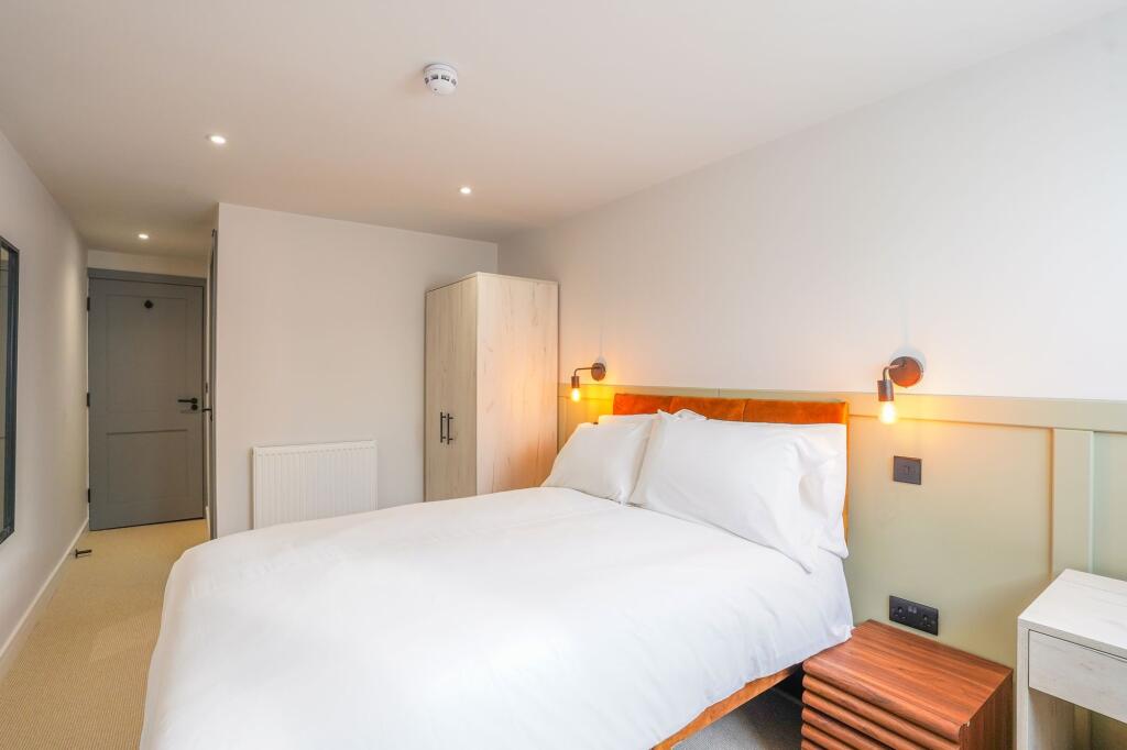 A modern, well-maintained double bedroom featur...