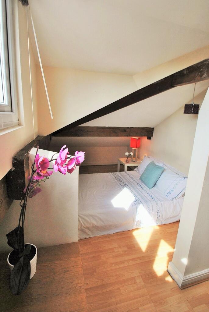 Charming double bedroom featuring natural light...