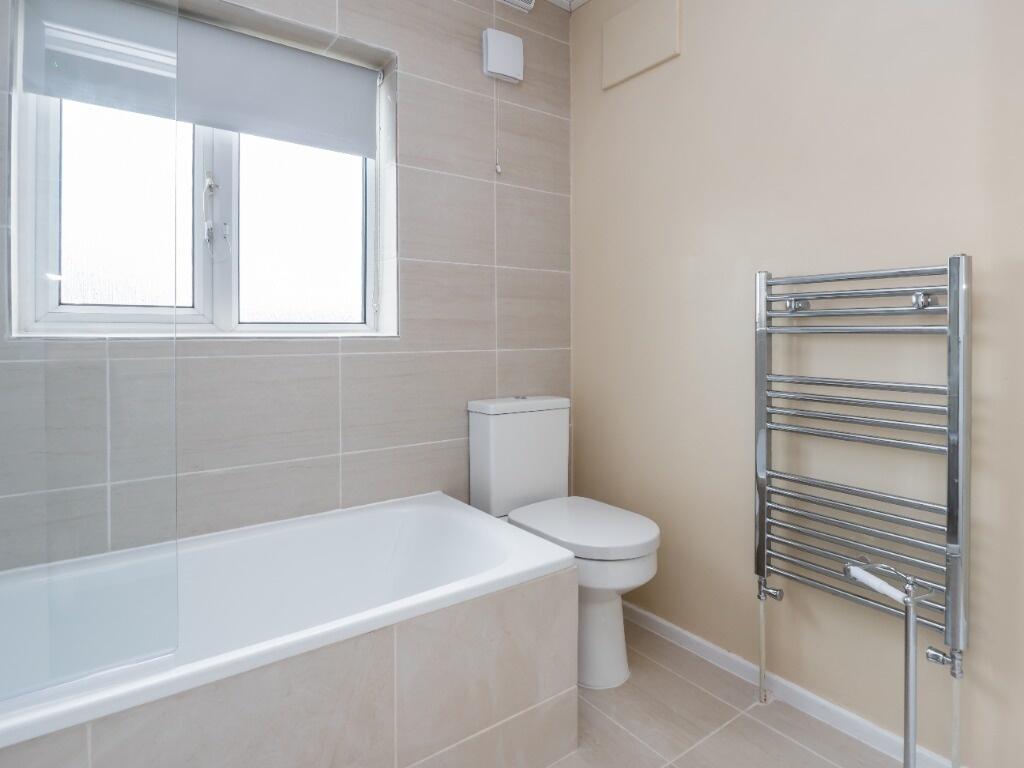 Bright and modern bathroom featuring a clean ba...