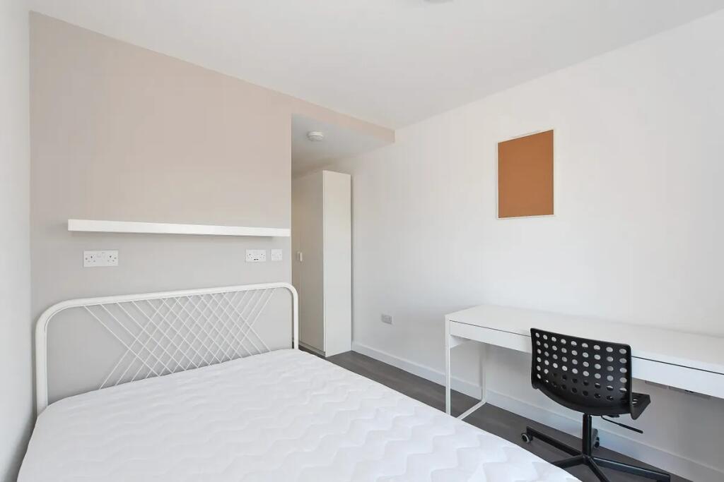 Bright and tidy single bedroom featuring a whit...