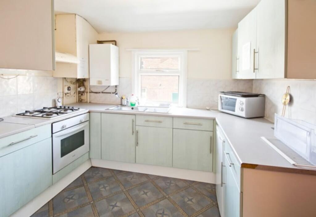 A bright and tidy kitchen equipped with modern ...