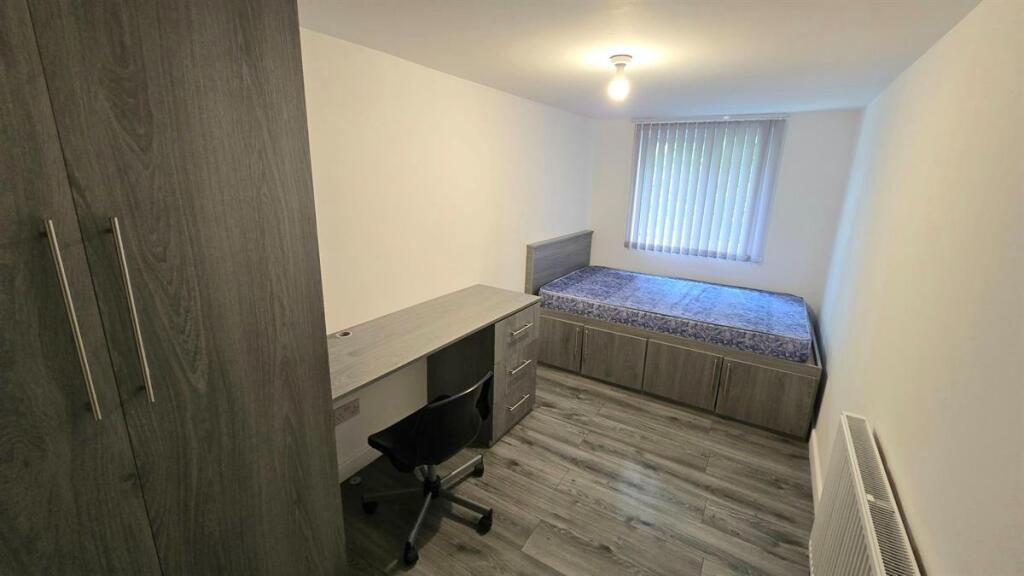 Neat single bedroom with built-in storage, stud...