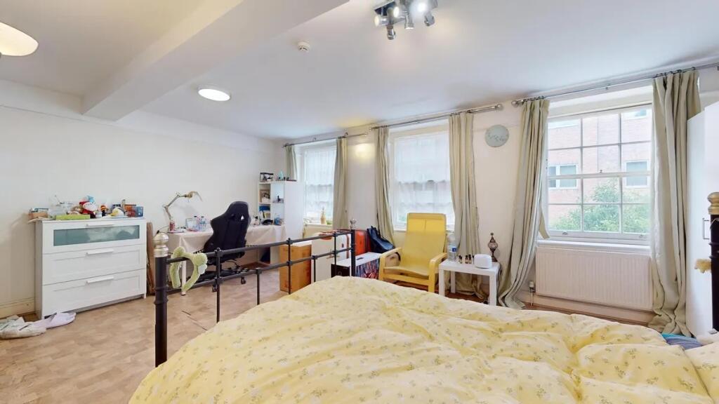 Bright and spacious master bedroom featuring th...