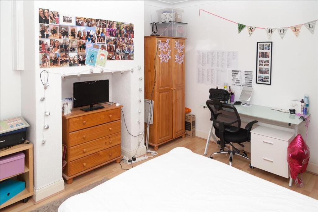 This inviting double bedroom features a cozy be...