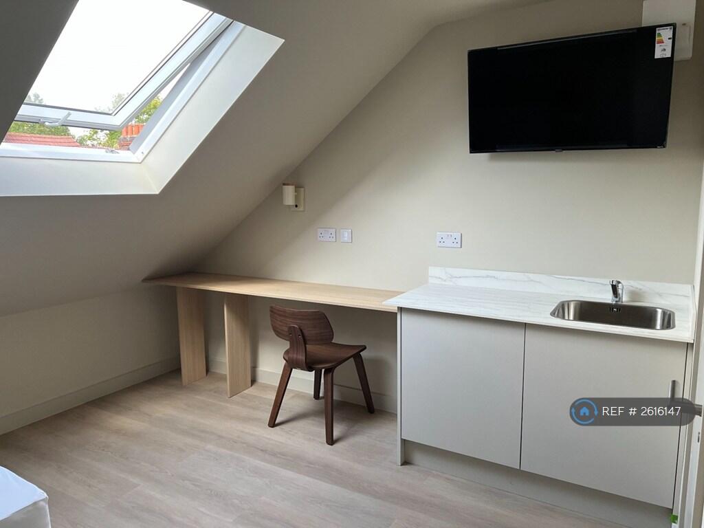 Private Kitchenette With a Sink And Fridge Freezer