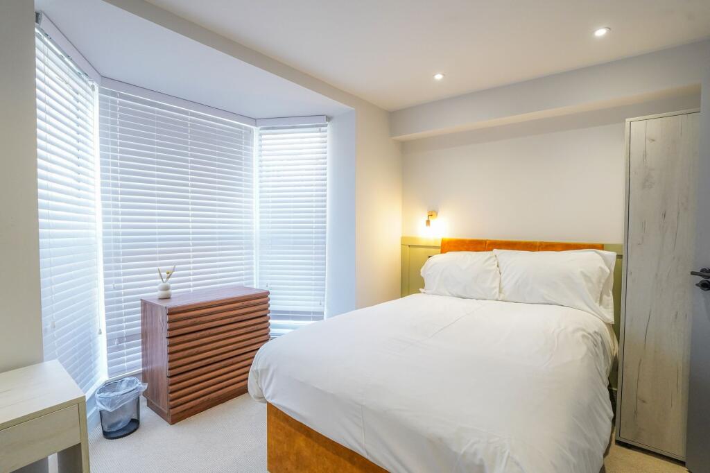 A bright and cozy double bedroom featuring a co...