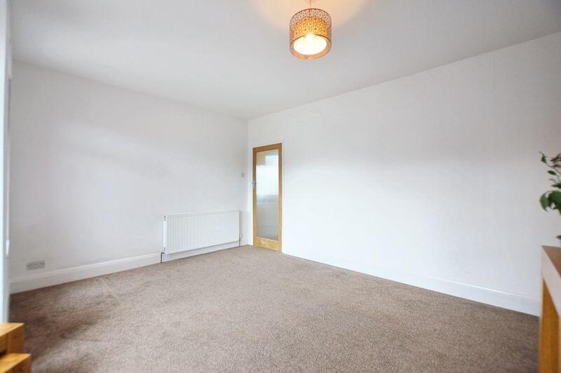 A bright and spacious living room featuring neu...