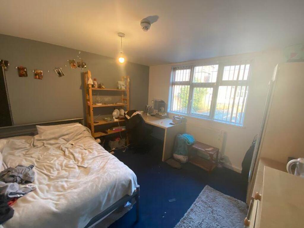 A spacious and well-lit double bedroom, ideal f...