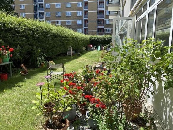 A well-maintained outdoor garden area with lush...