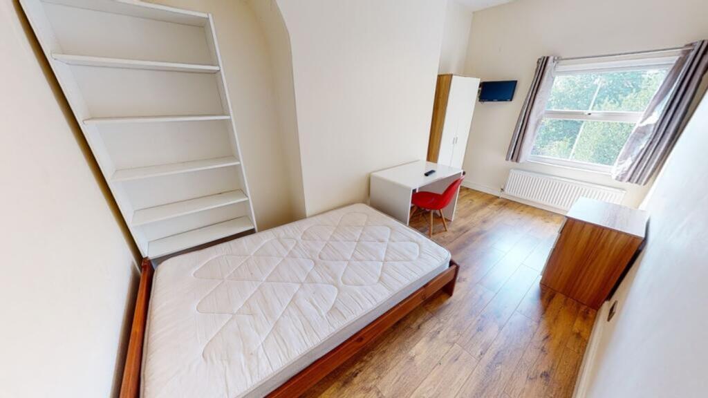 A bright and spacious double bedroom featuring ...