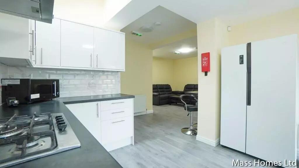 Bright and modern kitchen featuring sleek white...