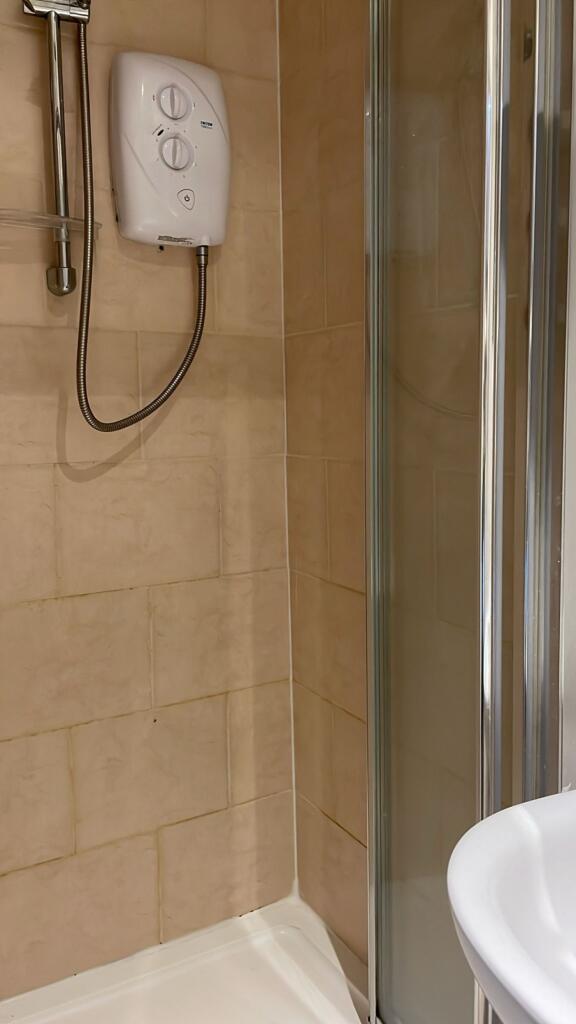 A modern bathroom featuring a sleek shower and ...