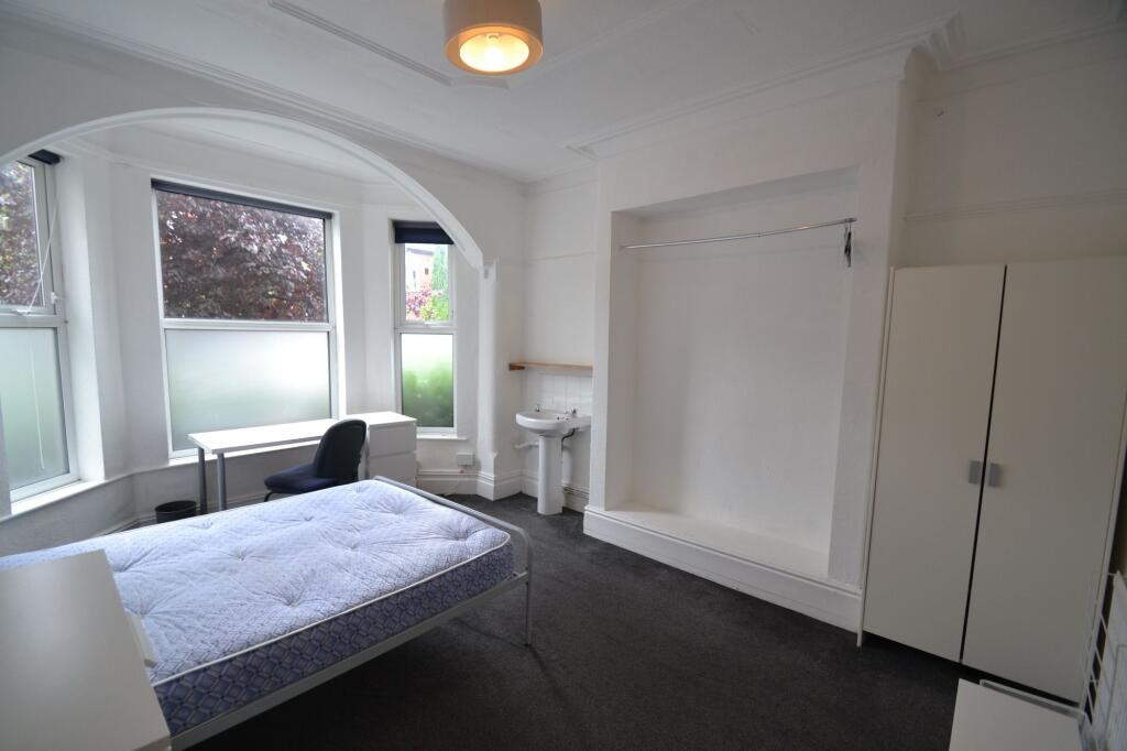 A bright and airy single bedroom featuring a la...