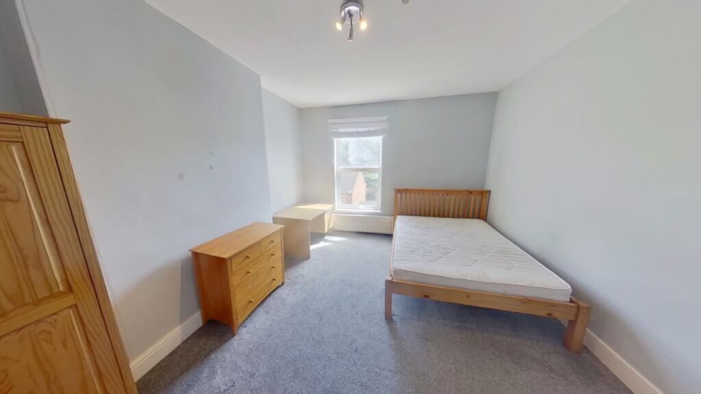 A spacious and bright double bedroom with natur...