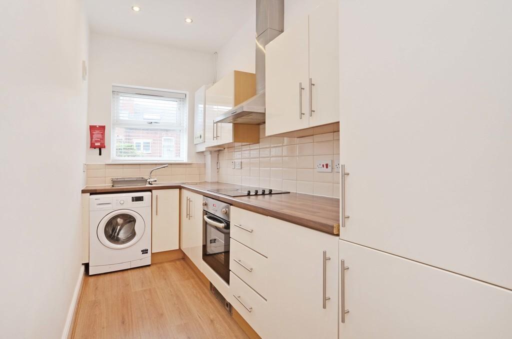 Bright and clean modern kitchen featuring ample...