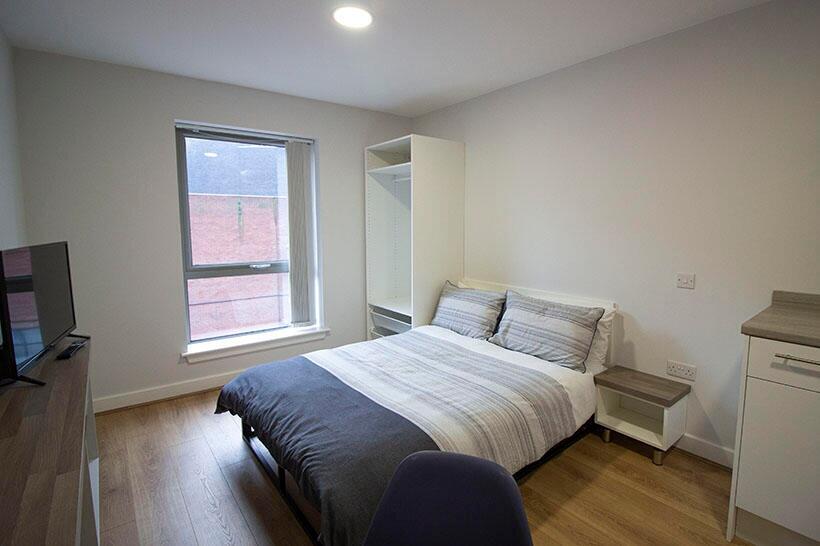 A bright and tidy double bedroom featuring a co...