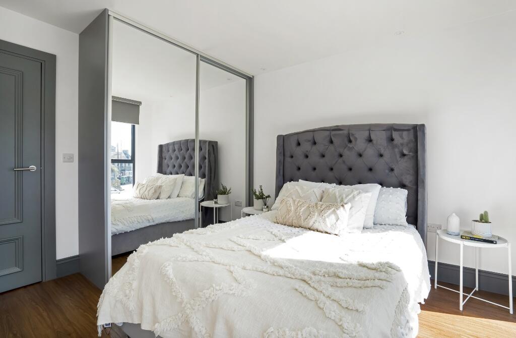 Bright and stylish double bedroom featuring a p...