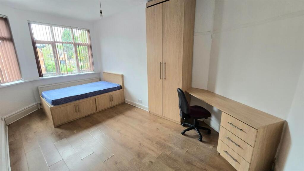 Bright, tidy bedroom with a large window, built...