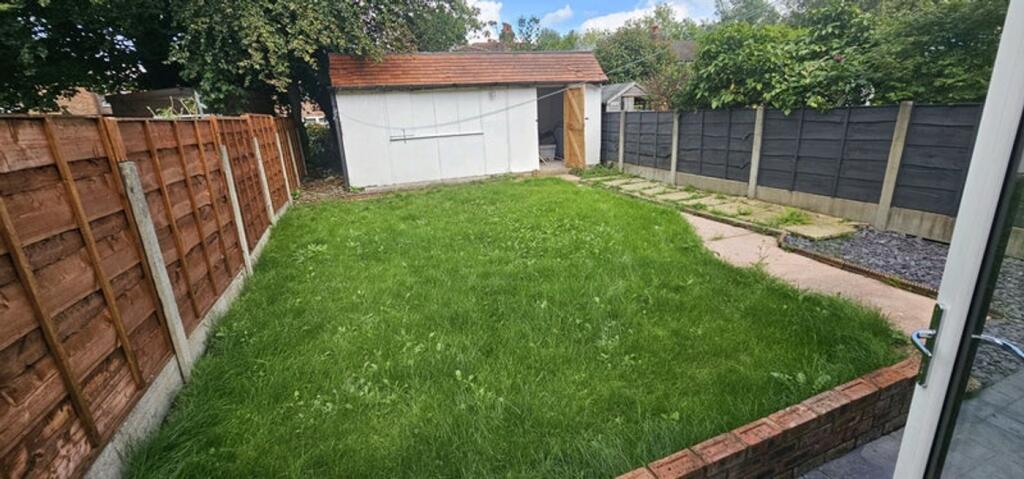 A beautifully maintained garden featuring a spa...