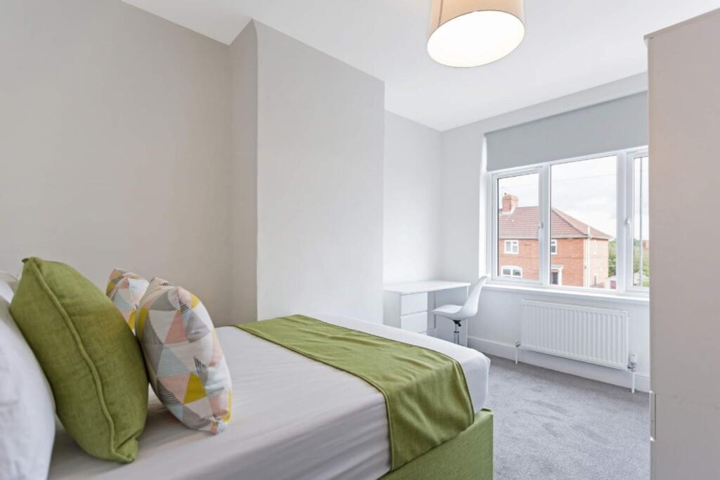 A bright and inviting double bedroom featuring ...