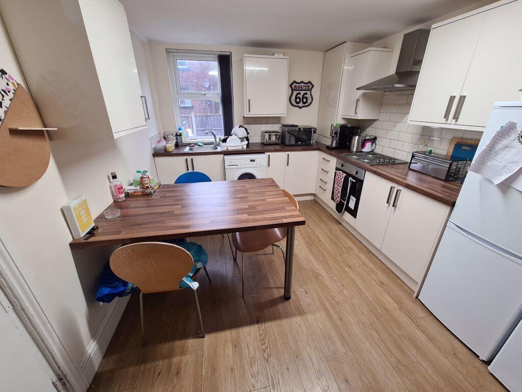 Bright and modern kitchen featuring ample count...