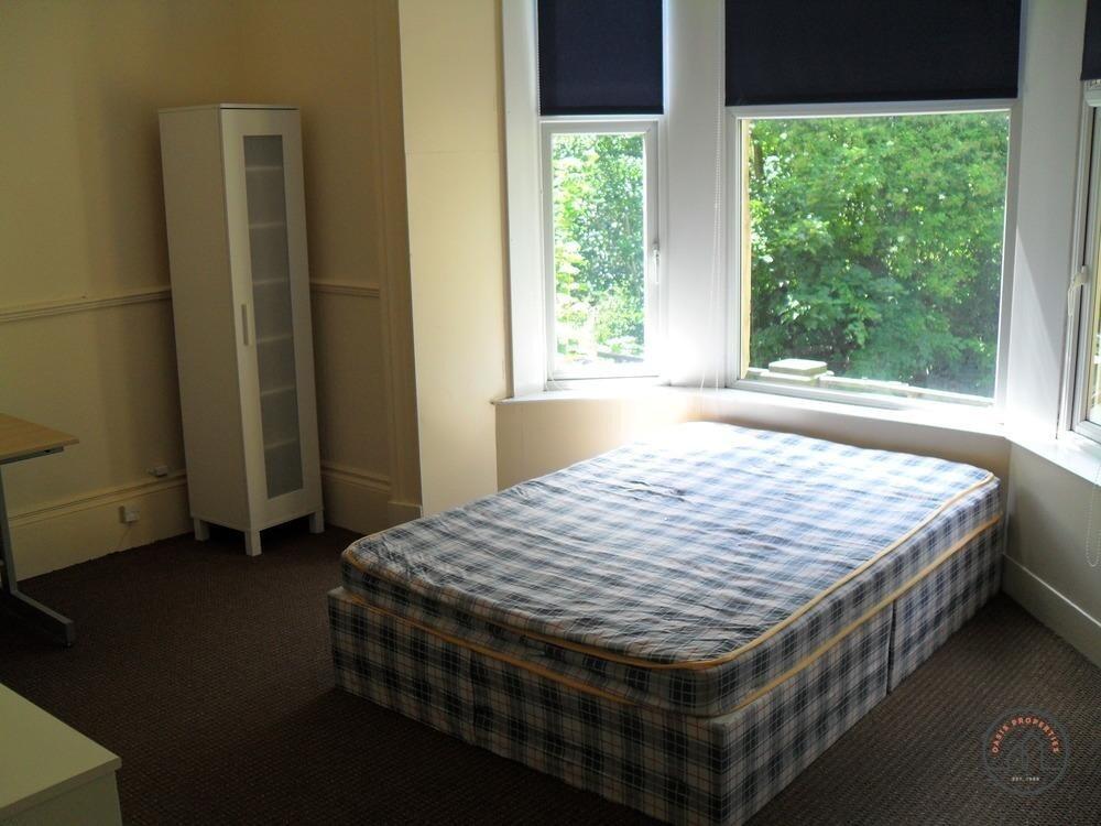 A bright and inviting double bedroom with large...