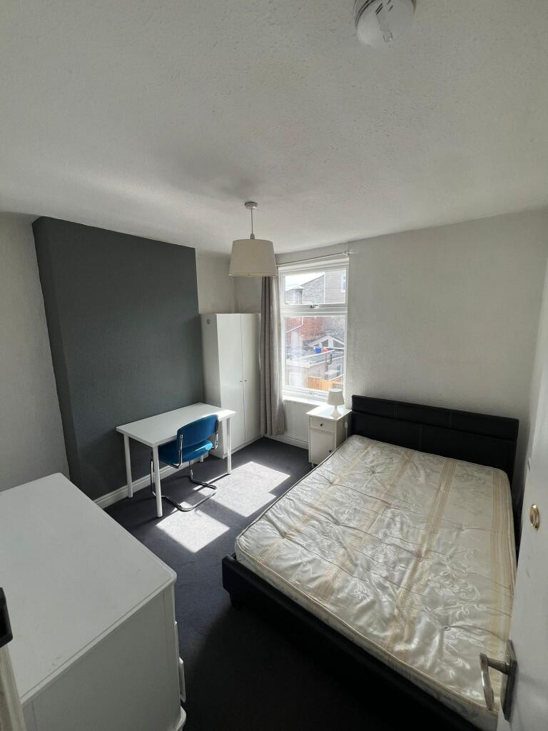 A bright and neat double bedroom featuring a co...