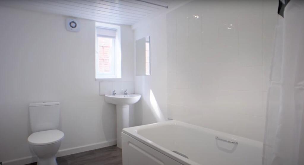 Bright and clean bathroom featuring a modern ba...