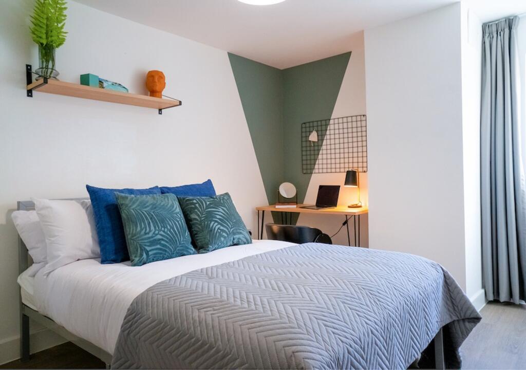 A modern double bedroom featuring stylish decor...