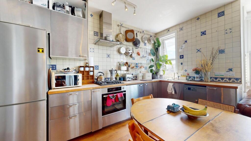 Bright and modern kitchen featuring stainless s...