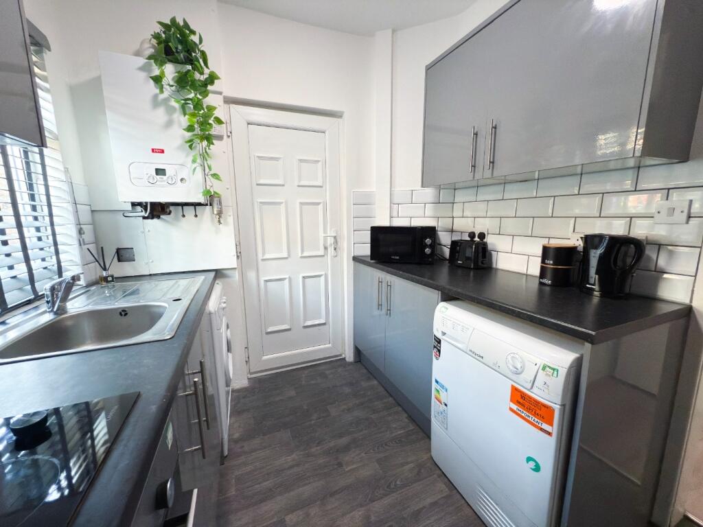 Bright modern kitchen with grey cabinetry, inte...