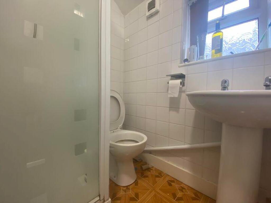 A tidy bathroom featuring a shower and modern f...