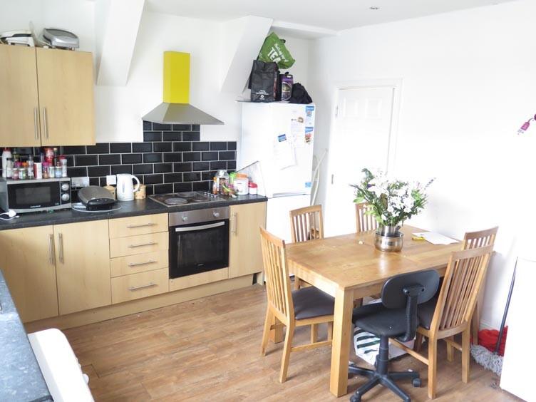 A modern, bright kitchen with wooden cabinets a...