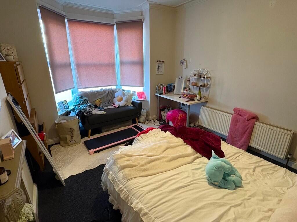 Bright and cozy master bedroom featuring a larg...