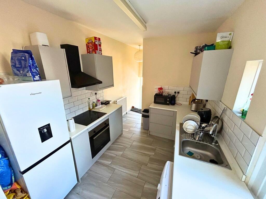 Bright and modern kitchen featuring a full-size...