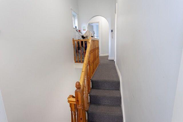 Bright and tidy hallway with clean carpeted flo...