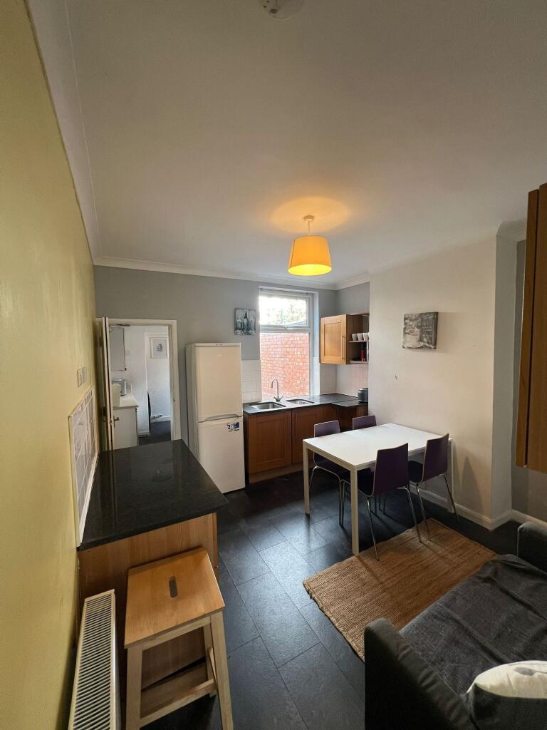 A bright and functional kitchen area with woode...