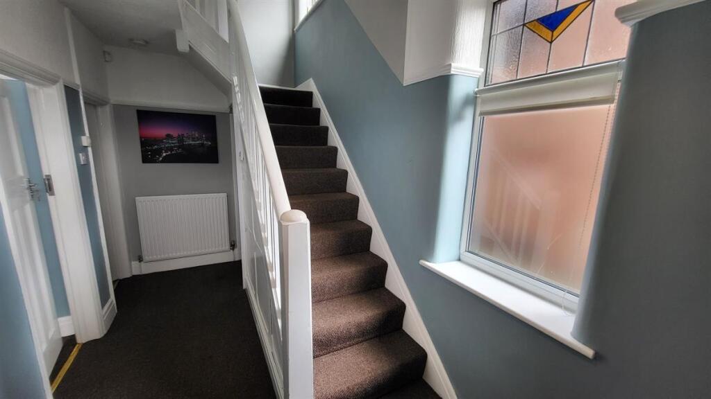 Bright and inviting hallway with natural light ...