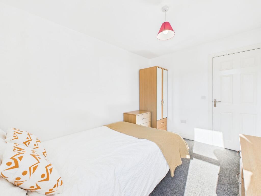 Bright and inviting double bedroom with natural...
