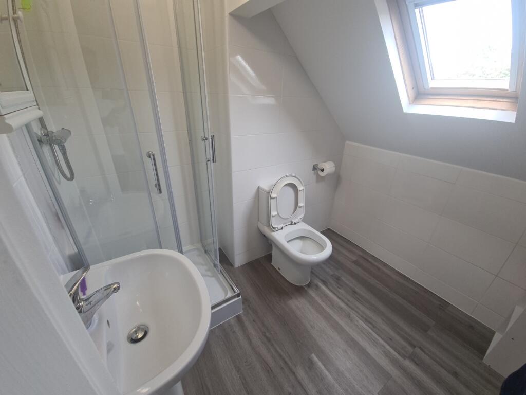 A bright, modern bathroom featuring a walk-in s...