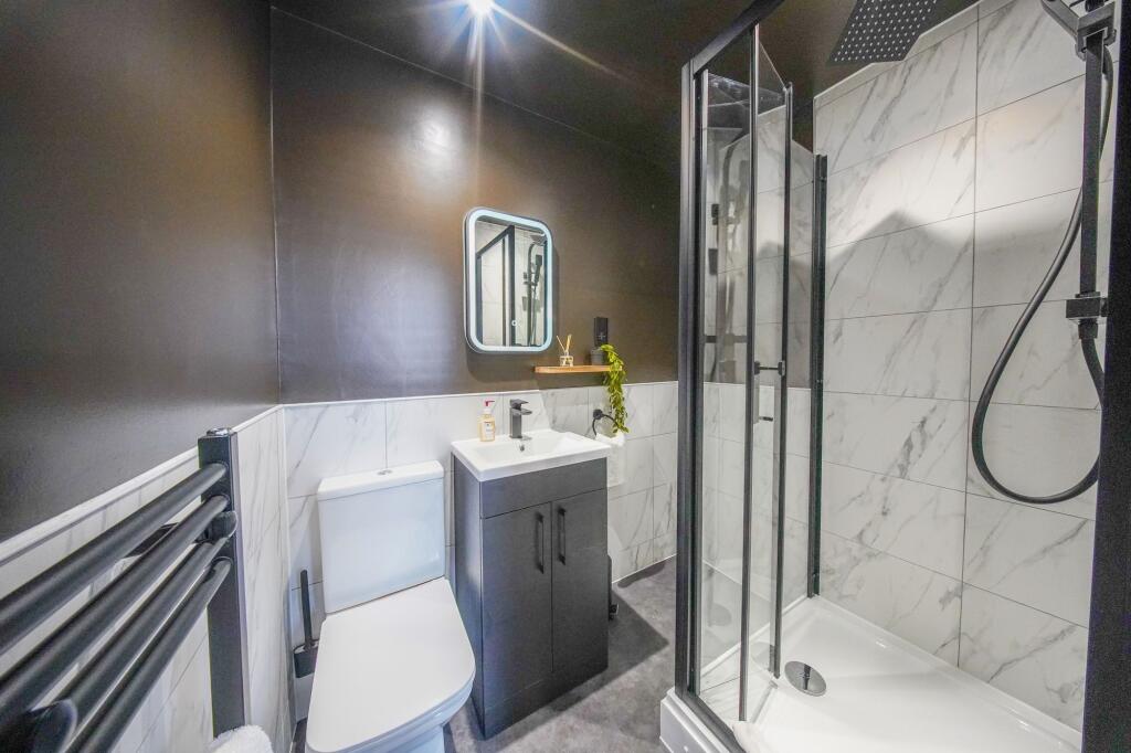 Modern bathroom featuring a sleek walk-in showe...