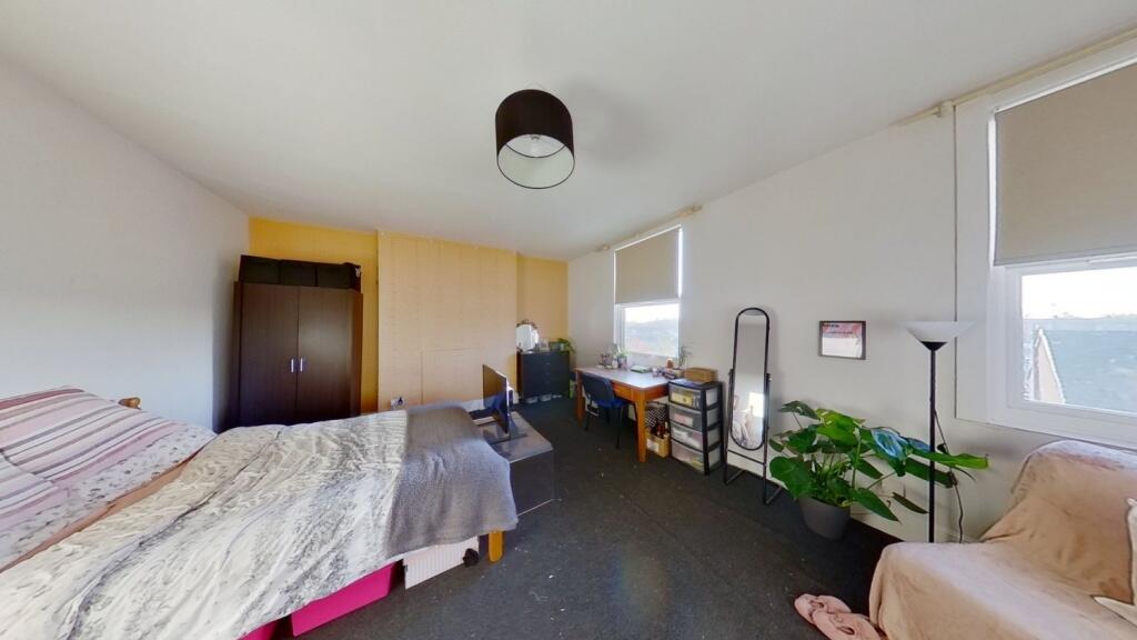 Bright and spacious bedroom featuring a double ...