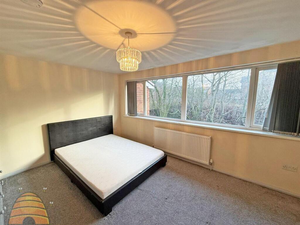 A bright and spacious double bedroom with large...