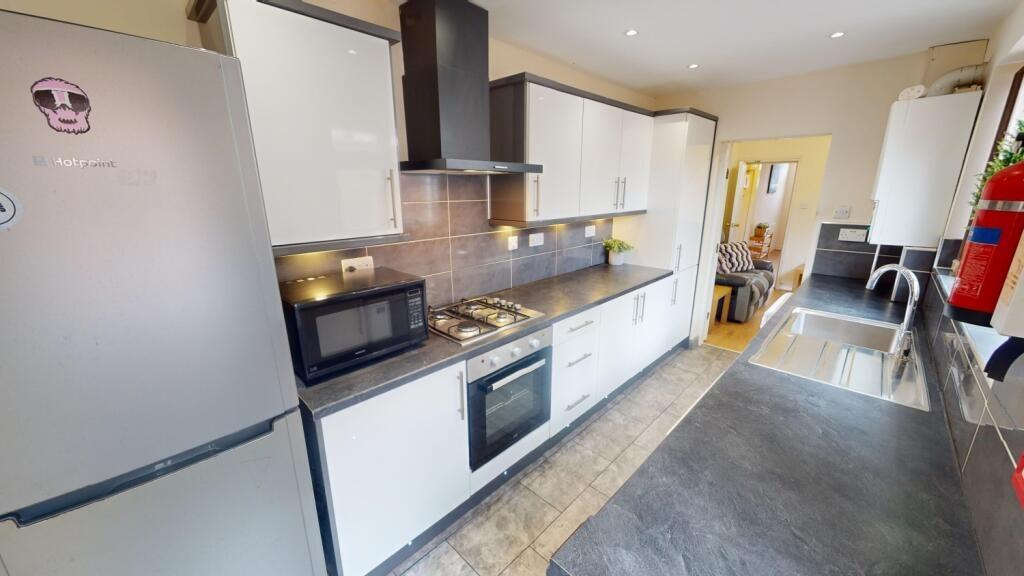Bright and modern kitchen featuring sleek white...