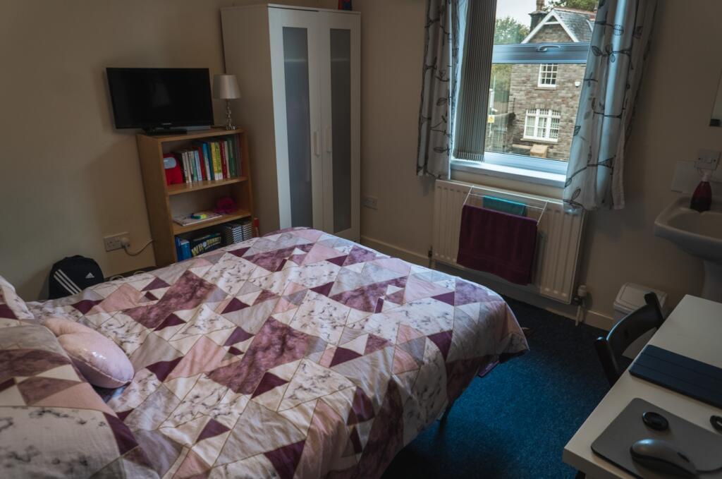 A cozy and inviting double bedroom with a brigh...