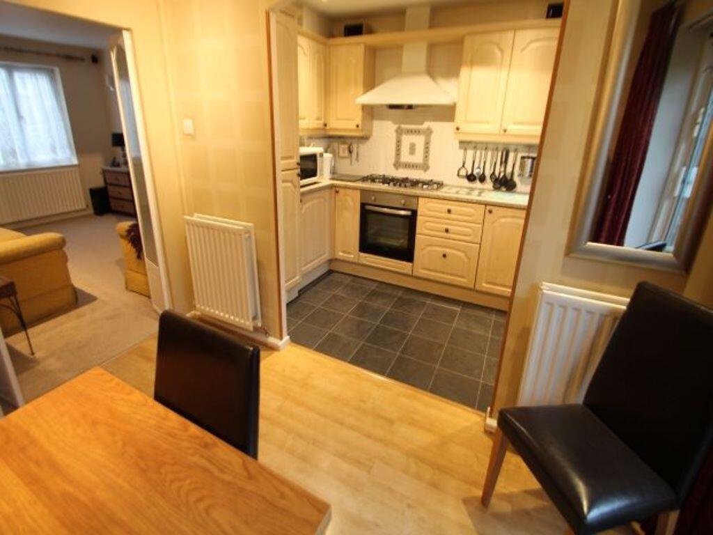 Well-kept kitchen opening into a comfortable li...