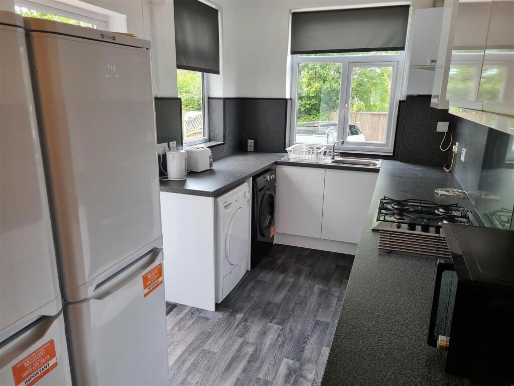 Bright and modern kitchen equipped with essenti...