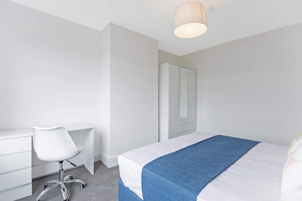 A bright and spacious double bedroom featuring ...