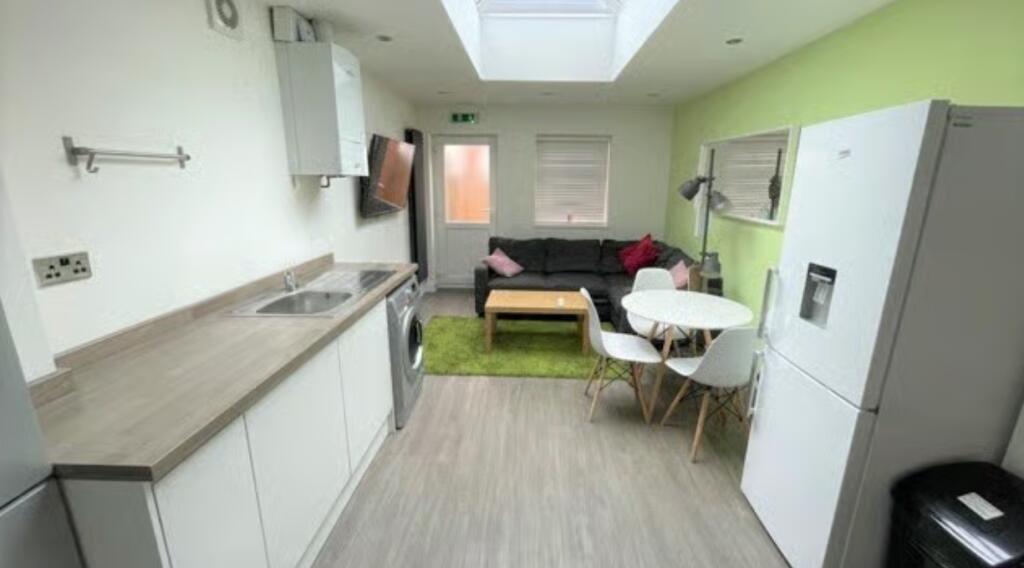 Bright and modern living area with a sleek kitc...