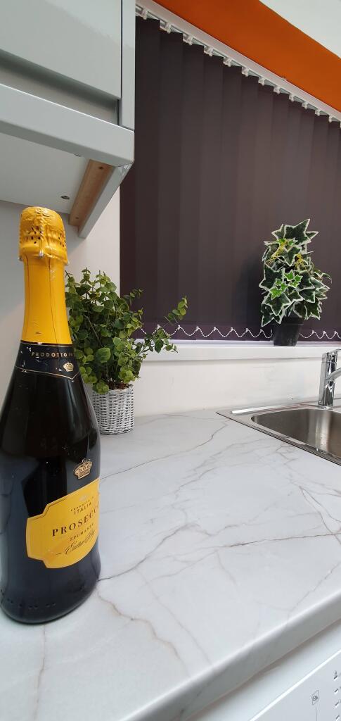 A modern kitchen featuring sleek marble counter...